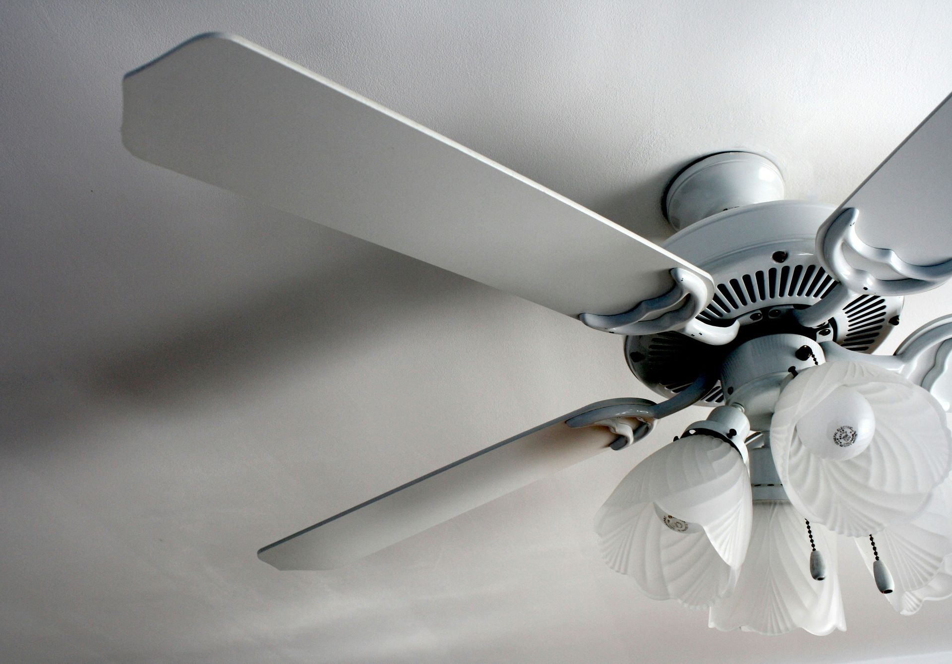a white ceiling fan in a white room